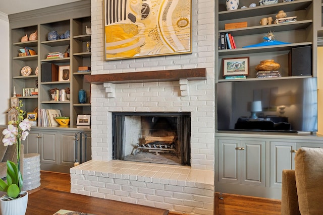 interior space featuring a brick fireplace and dark wood finished floors