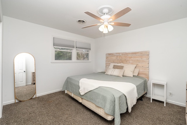 bedroom featuring dark carpet, visible vents, and baseboards