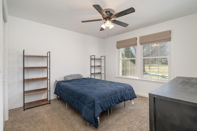 carpeted bedroom with baseboards and a ceiling fan