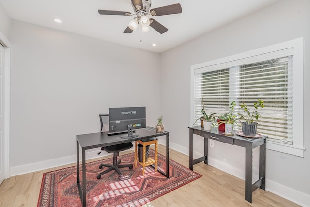 home office featuring light wood finished floors, recessed lighting, a ceiling fan, and baseboards