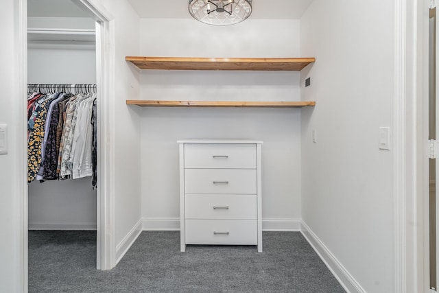 spacious closet featuring dark carpet