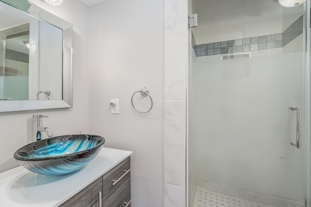 full bath with a stall shower and vanity