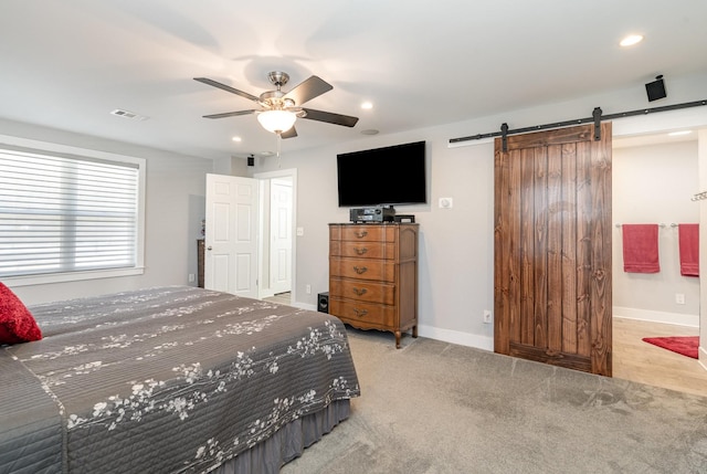 bedroom featuring a barn door, baseboards, a ceiling fan, light colored carpet, and recessed lighting