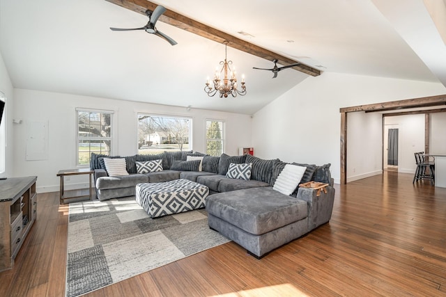 living area featuring a wealth of natural light, lofted ceiling with beams, and wood finished floors