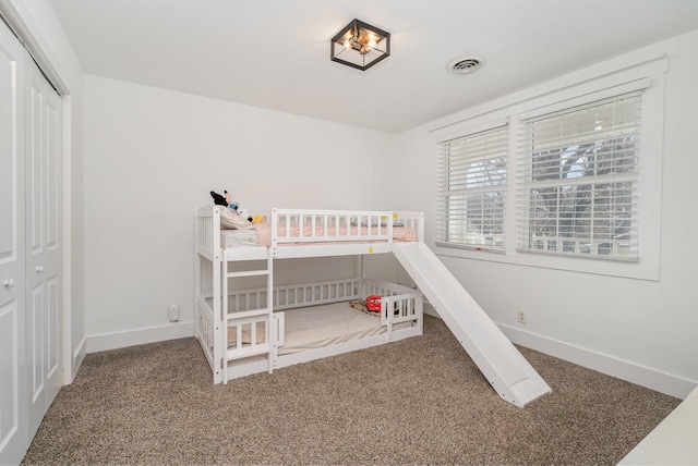 bedroom with carpet flooring, visible vents, and baseboards