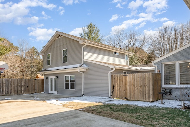 view of front of home with a patio area and fence