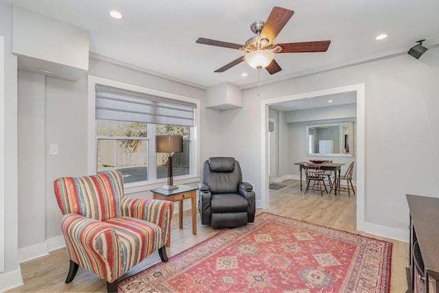 living area with light wood-type flooring, baseboards, and recessed lighting