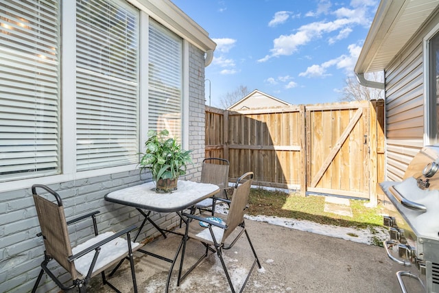 view of patio featuring a gate and fence