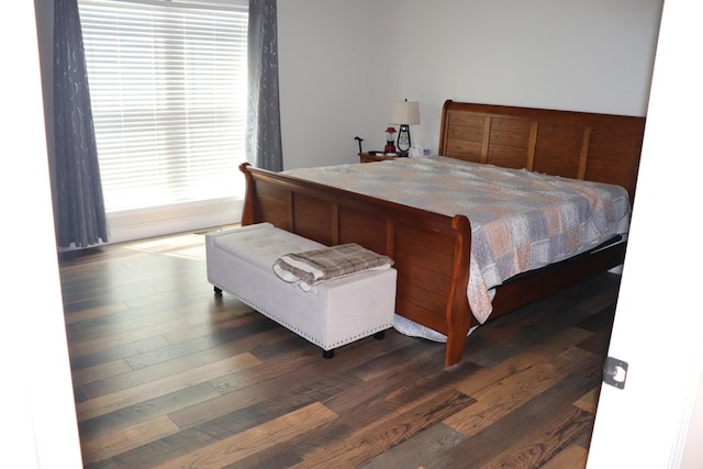 bedroom featuring dark wood-style flooring