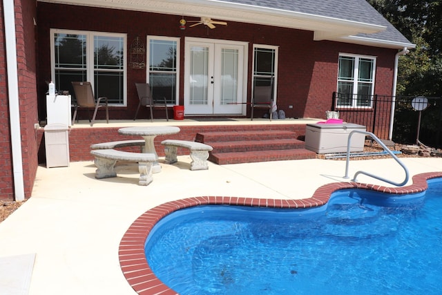 pool with a patio, french doors, and fence