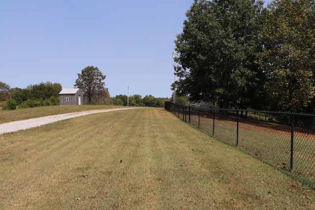 view of yard featuring driveway and fence