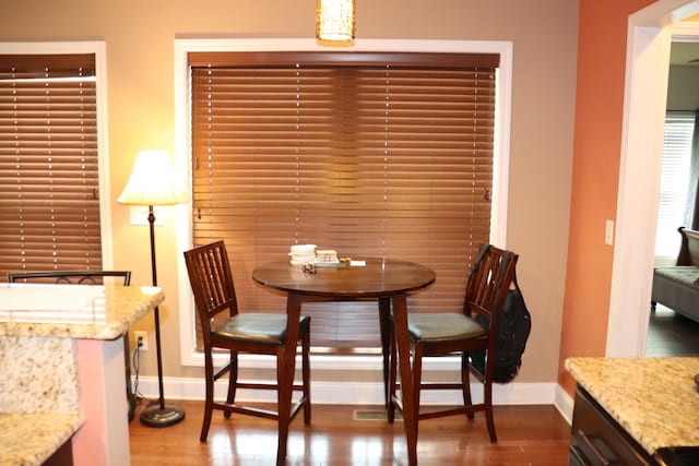 dining area featuring wood finished floors and baseboards