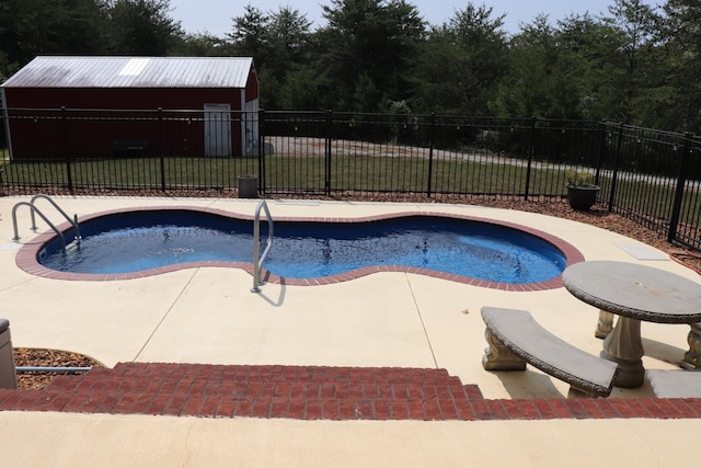 view of pool featuring a lawn, a patio area, fence, and a fenced in pool