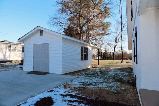 snow covered structure with an outdoor structure