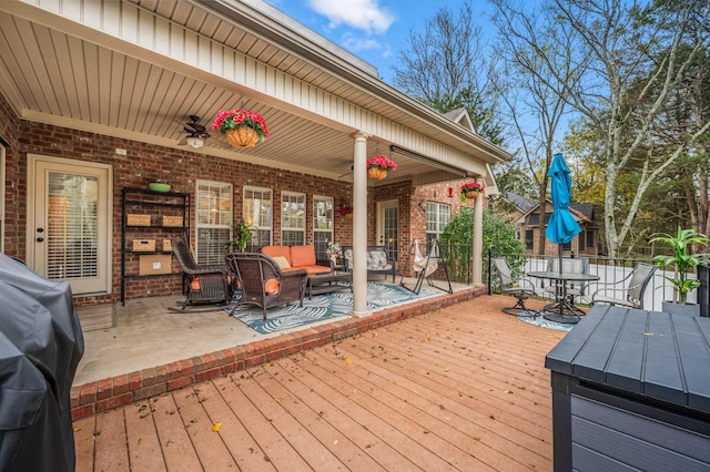 wooden terrace with a ceiling fan, outdoor dining area, and outdoor lounge area