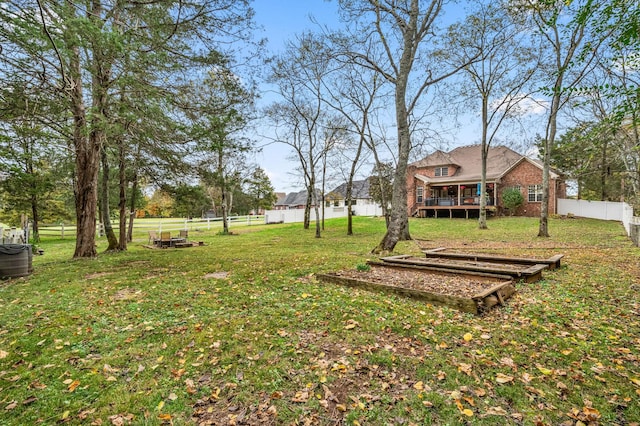 view of yard with a fenced backyard and a wooden deck