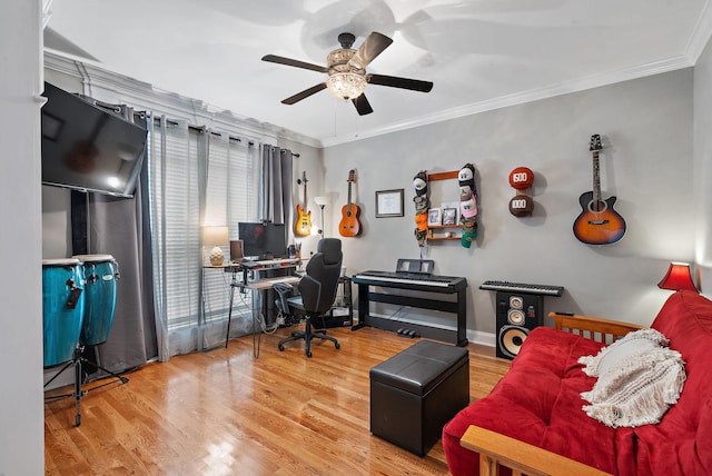 office featuring crown molding, baseboards, ceiling fan, and wood finished floors