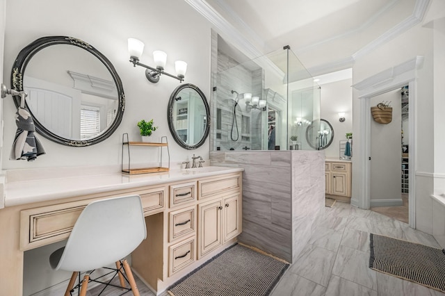 full bath with marble finish floor, tiled shower, crown molding, and vanity