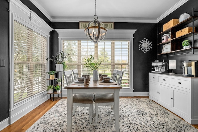 office area featuring ornamental molding, a chandelier, light wood-style flooring, and baseboards