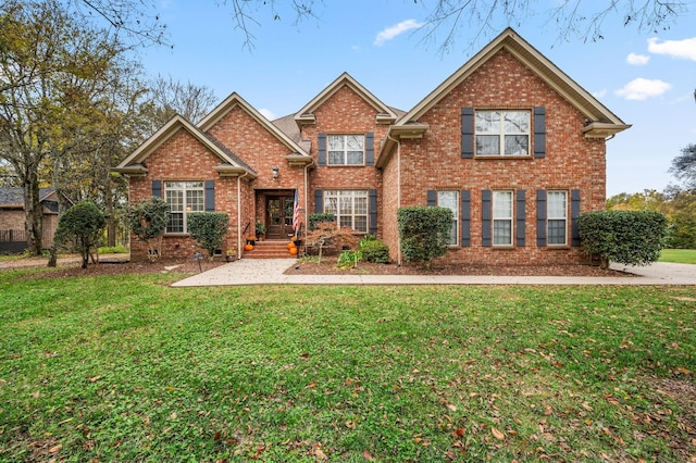 traditional-style house with brick siding and a front yard