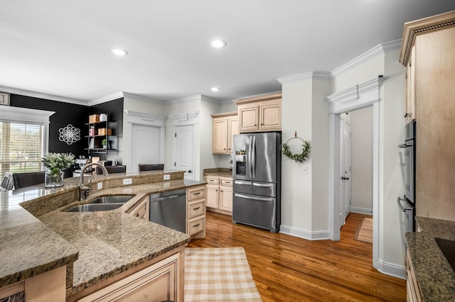 kitchen with ornamental molding, appliances with stainless steel finishes, dark wood-style flooring, and a sink