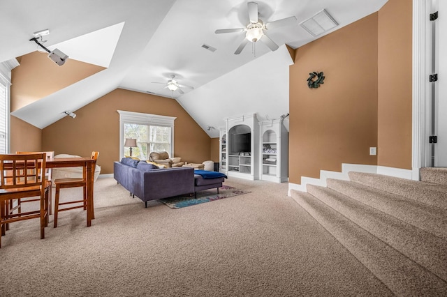 living room with lofted ceiling, visible vents, ceiling fan, and carpet