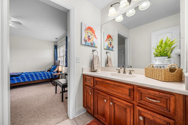 bathroom with ceiling fan, tile patterned flooring, and vanity