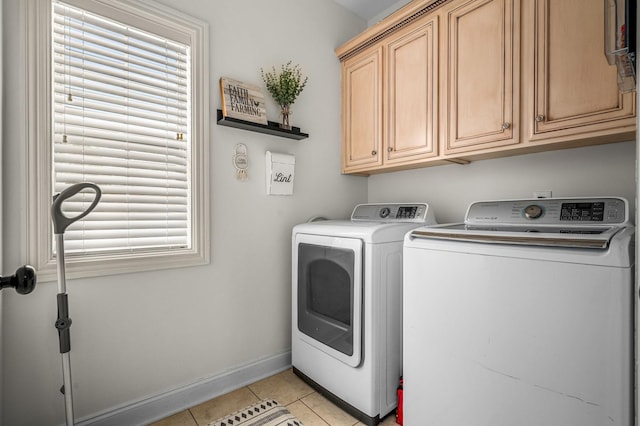 laundry room with washer and dryer, cabinet space, baseboards, and light tile patterned floors