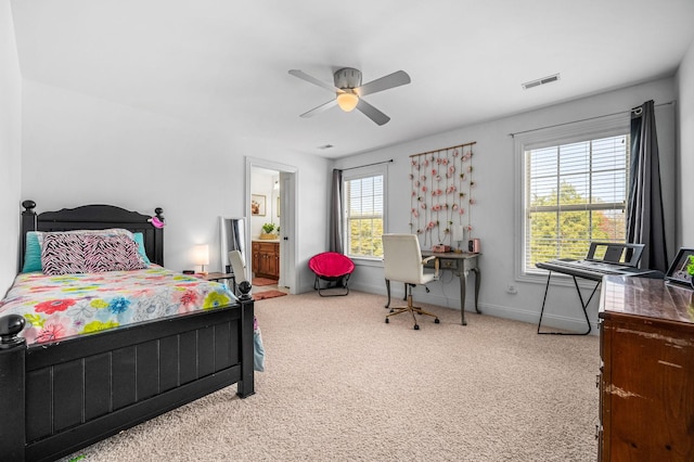 bedroom with ceiling fan, connected bathroom, visible vents, baseboards, and carpet