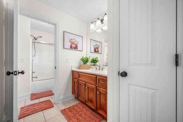 bathroom with tile patterned flooring, vanity, baseboards, and bathing tub / shower combination