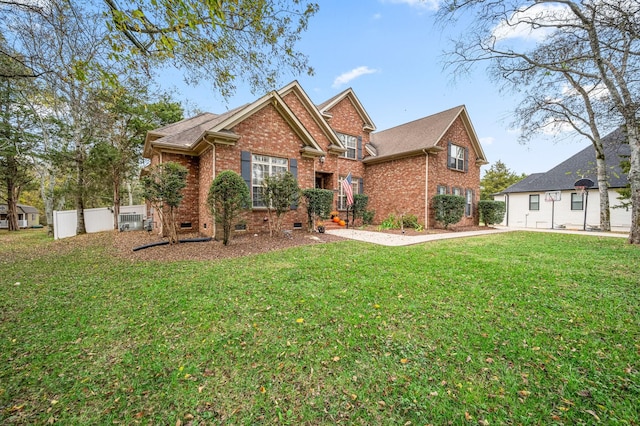 view of front of property featuring crawl space, brick siding, fence, and a front lawn