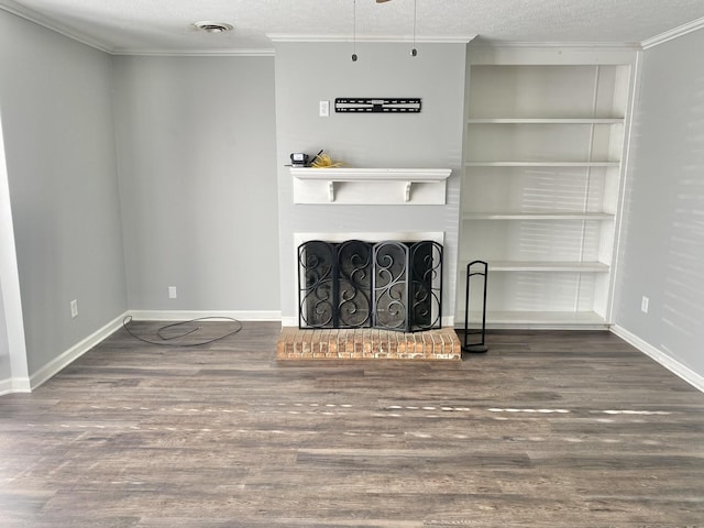 unfurnished living room featuring a textured ceiling, a fireplace, dark wood-type flooring, and crown molding