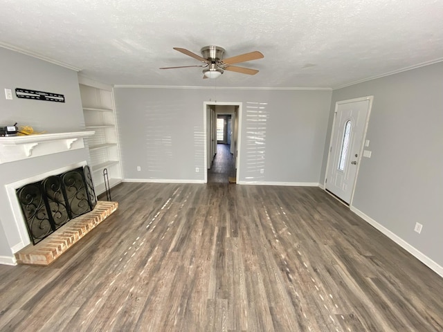 unfurnished living room featuring built in features, a fireplace, a textured ceiling, and ornamental molding