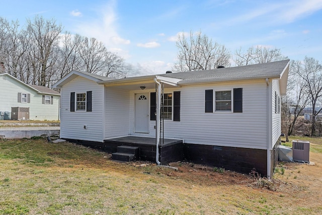 view of front of house with central AC, a front lawn, and crawl space