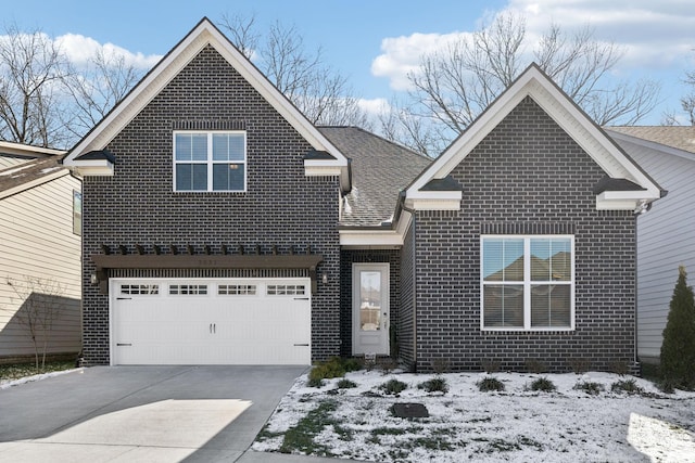 traditional-style home featuring driveway, brick siding, roof with shingles, and an attached garage