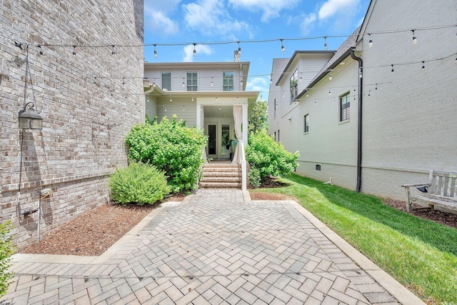 back of property with a patio and a lawn