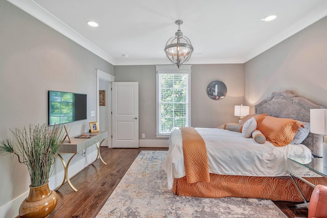 bedroom with baseboards, ornamental molding, dark wood-style flooring, a chandelier, and recessed lighting