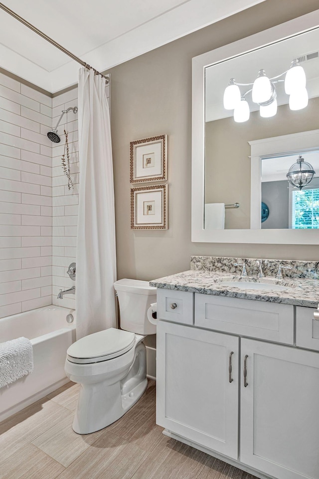 bathroom with toilet, shower / bathtub combination with curtain, and vanity