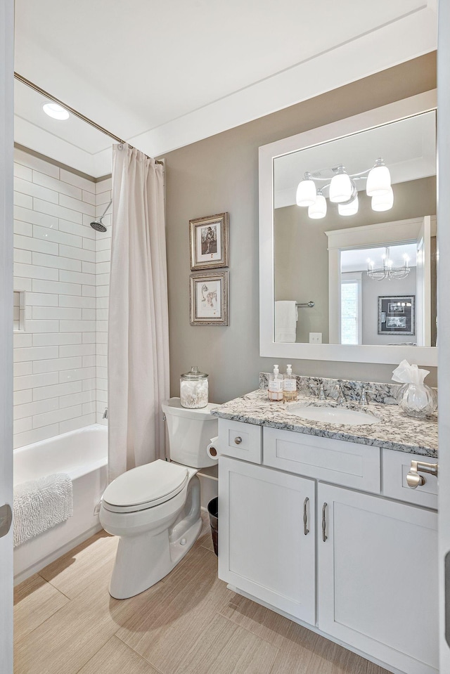 full bath featuring toilet, an inviting chandelier, shower / bath combination with curtain, and vanity