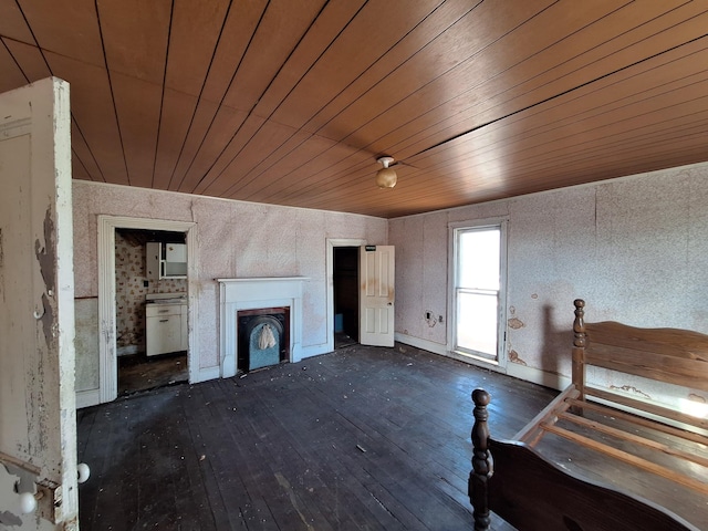 unfurnished bedroom featuring dark wood-type flooring, wood ceiling, and a fireplace