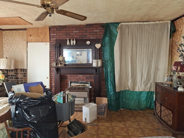 living area featuring a ceiling fan and a textured ceiling