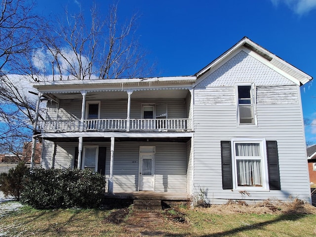 view of front of house with a balcony and covered porch