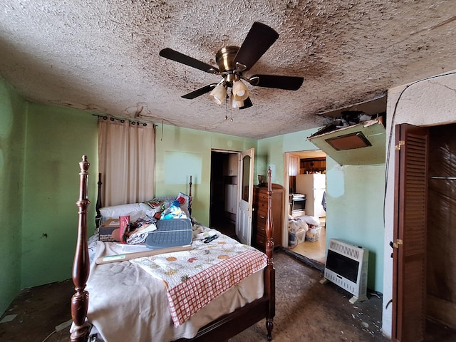 bedroom with a textured ceiling, a ceiling fan, and heating unit