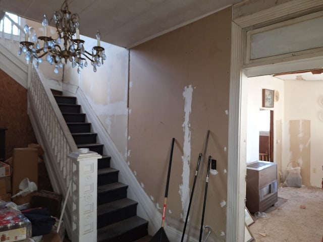 staircase featuring an inviting chandelier