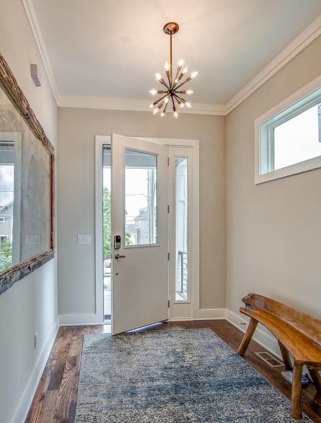 entryway with dark wood-style flooring, a healthy amount of sunlight, and crown molding