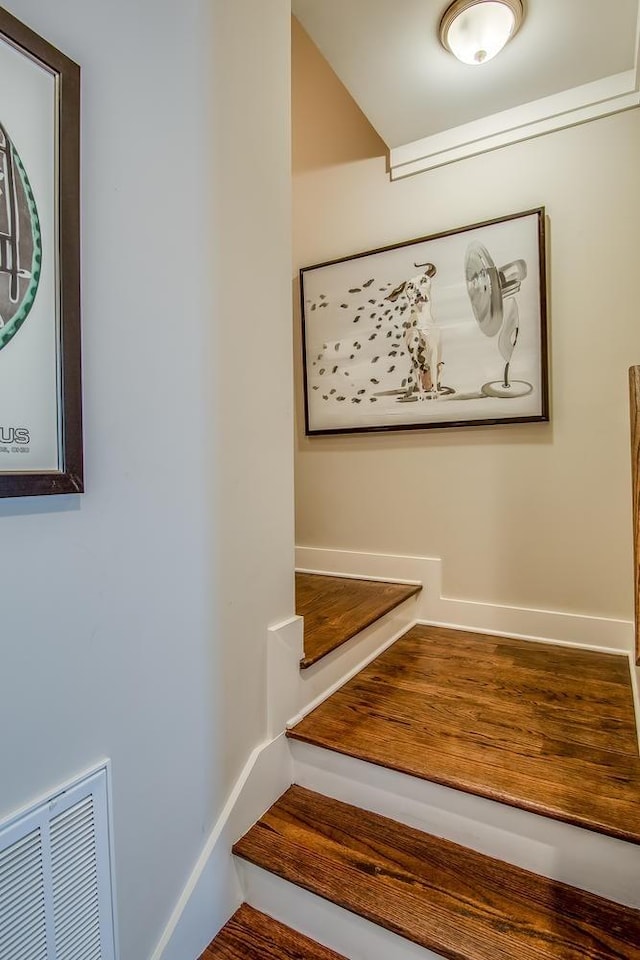 stairs featuring visible vents and baseboards