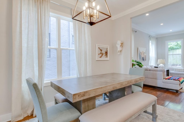 dining area featuring a notable chandelier, recessed lighting, crown molding, and wood finished floors