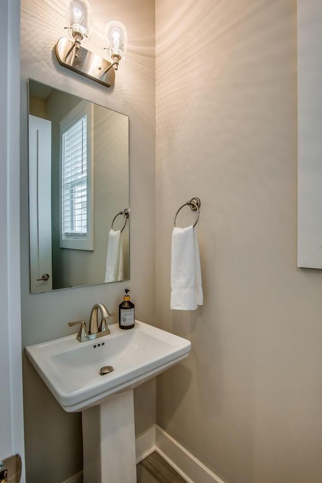 bathroom with a sink and baseboards