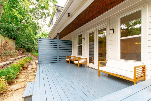 wooden terrace featuring fence and an outdoor hangout area