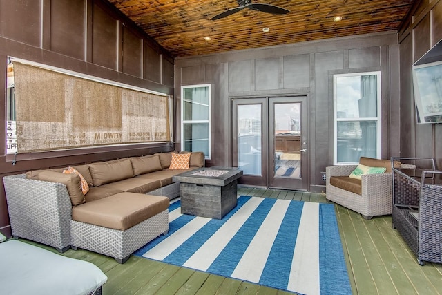 sunroom / solarium featuring wood ceiling and a ceiling fan